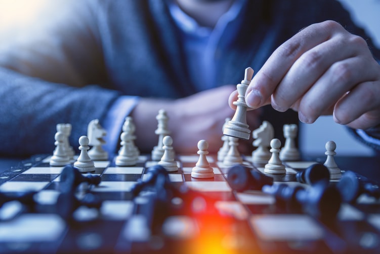 man playing chess - chess board and pawns